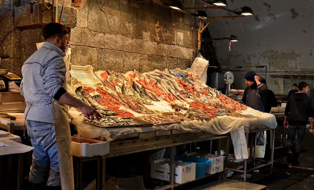 Vendors selling fishes at A' Piscaria Mercato del Pesce