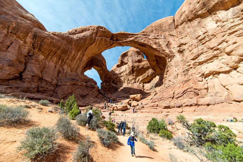 People walking under Double Arch