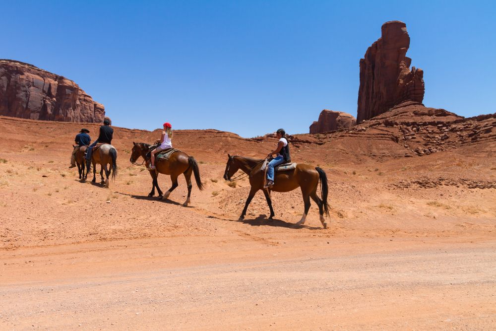 People horseback riding at Arches National Park