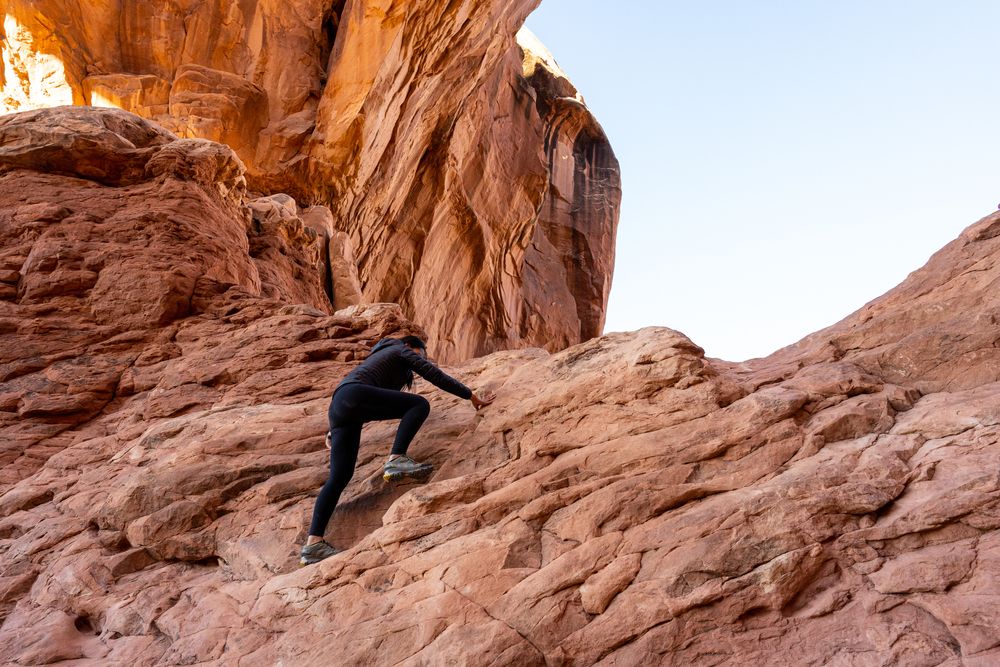 A person rock climbing at Arches National Park