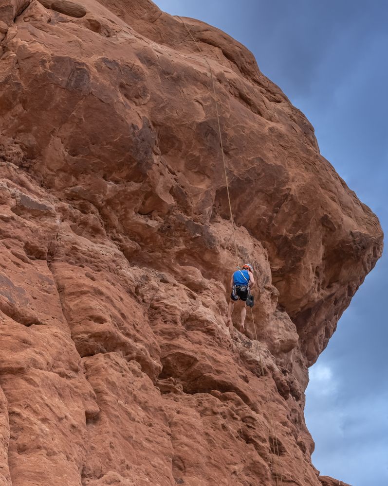 A person rock climbing at Arches National Park