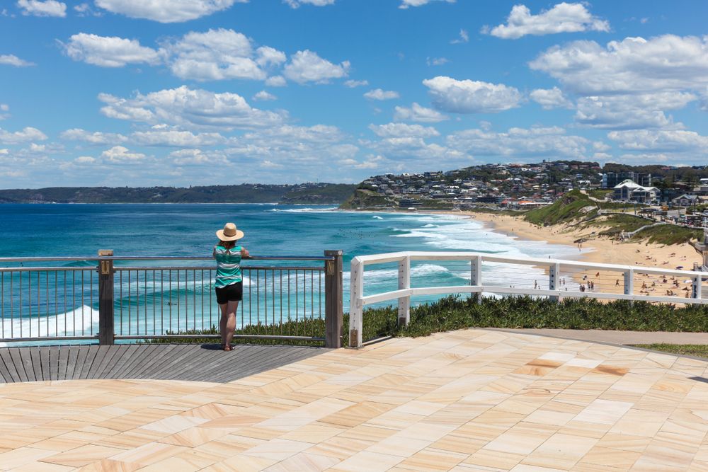 A young women enjoying the amazing view of the ocean from Bathers Way