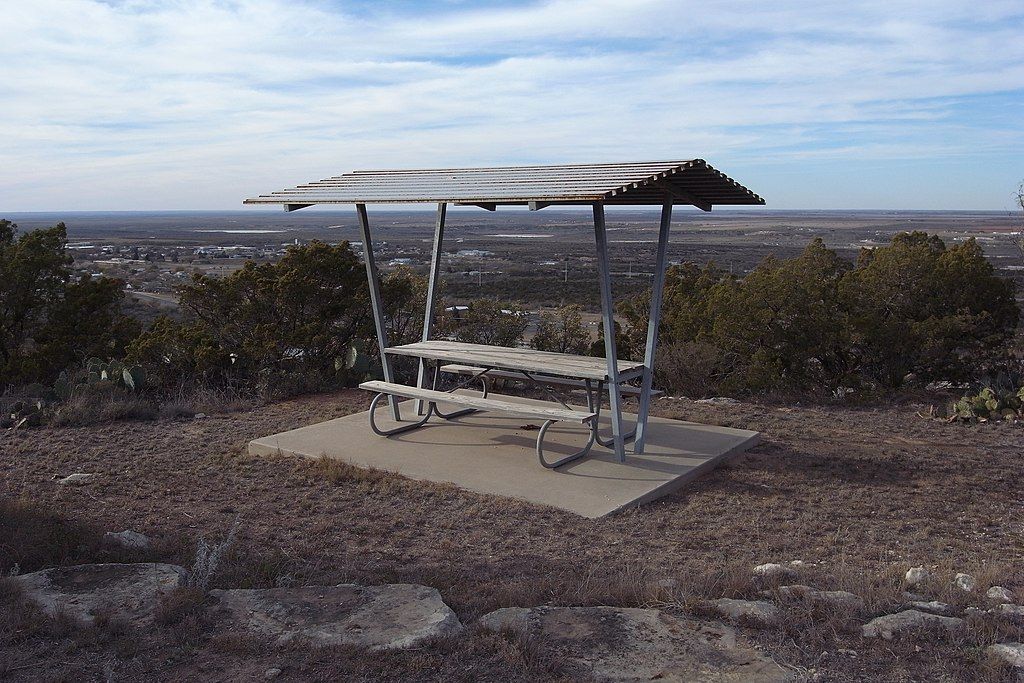A picnic table with a view of the city at Big Spring State Park
