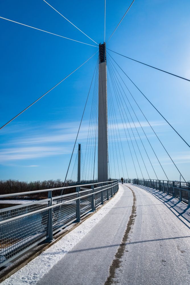 A man walking on the Bob Kerrey Pedestrian Bridge