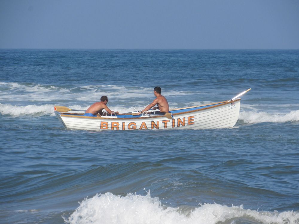 Two people riding a boat on Brigantine Beach