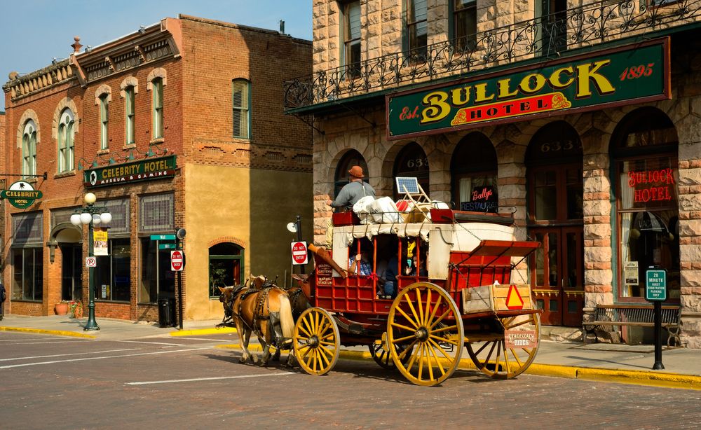 Horse carriage moving past the Bullock Hotel