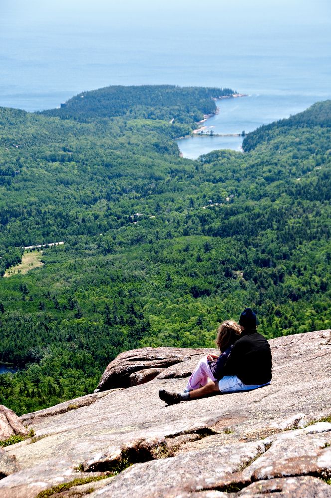 A young couple enjoying nature from Cadillac Mountain