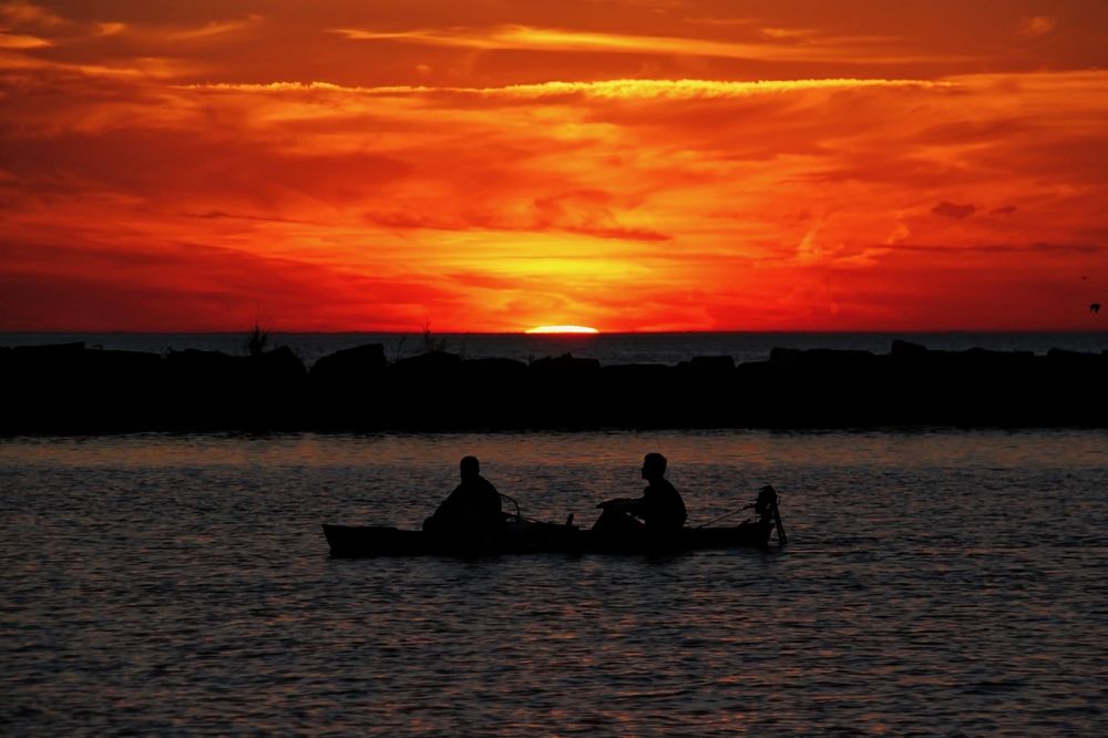People in Canoe watching sunset
