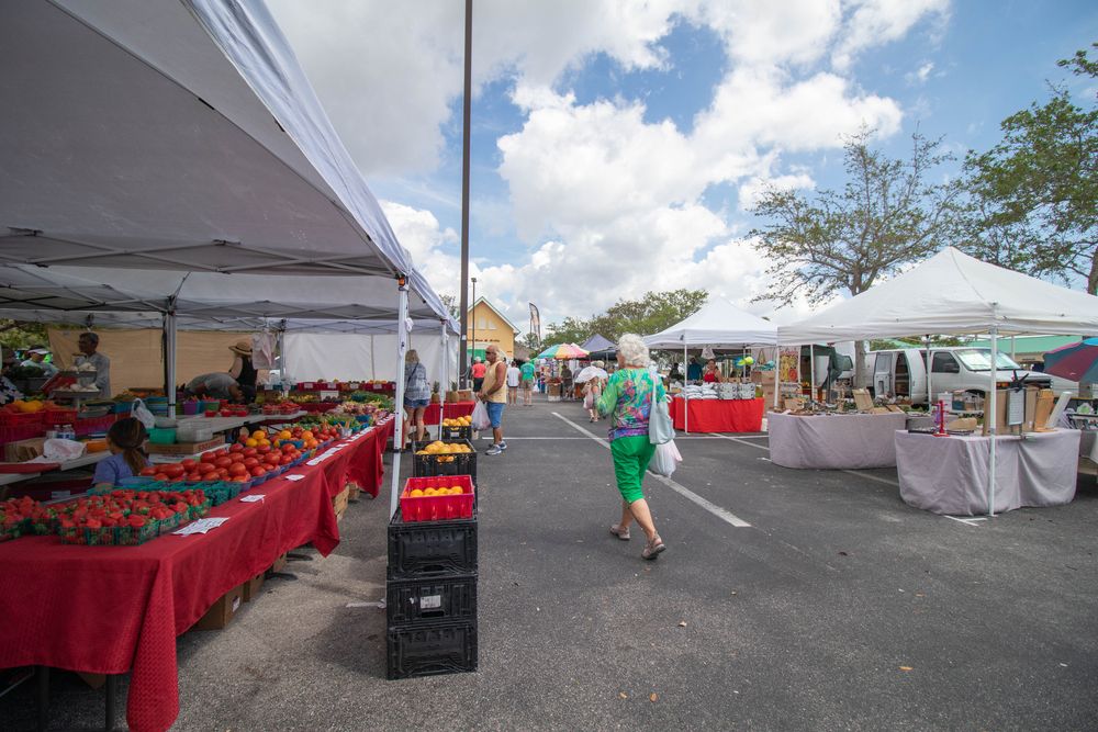 Visitors purchasing fresh fruits and vegetables at Cape Coral Farmers Market