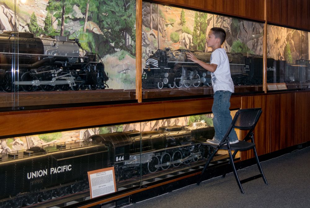 A young boy curiously looking at the displays at Colorado Railroad Museum