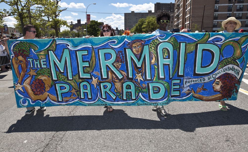 People holding the tarp for Mermaid parade