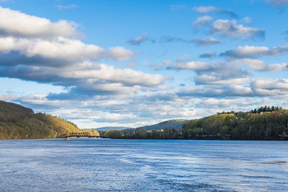 View of the gentle Connecticut River flowing with raws of trees on both the sides