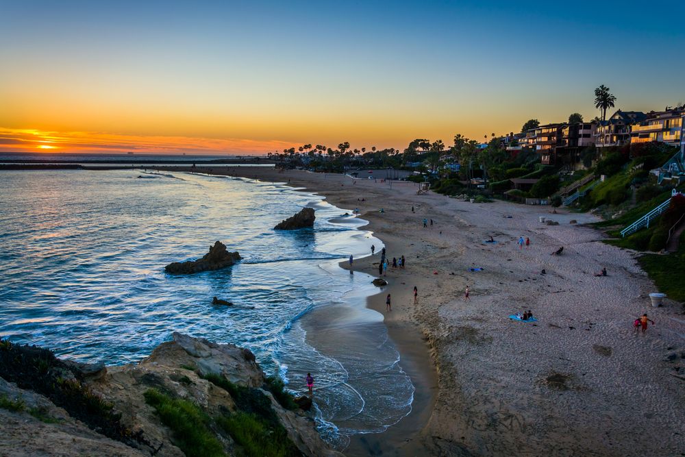 People enjoying the sunset at Corona del Mar State Beach