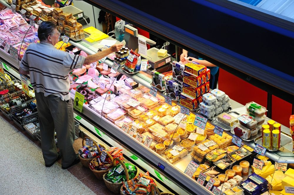A man buying food from a stall at Derby Market Hall