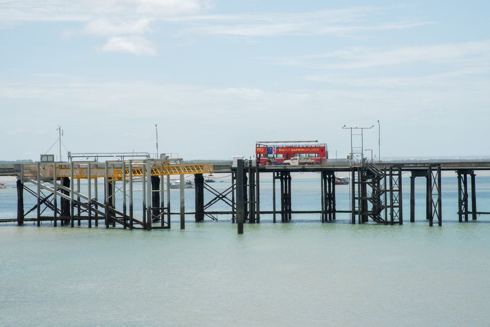 Beautiful view of a Double-Decker Bus passing over a waterbody on a bridge