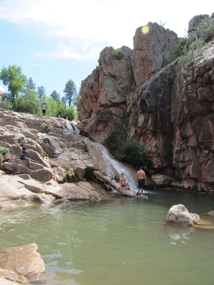 People swimming at Ellison Creek Waterfall