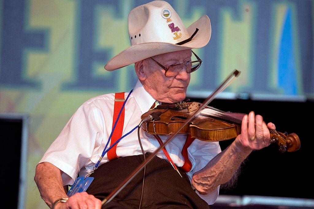 An old man playing violin at Festival International de Louisiane