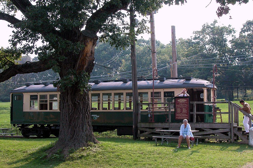 Picnic bench in front of a display trolley at Fox River Trolley Museum