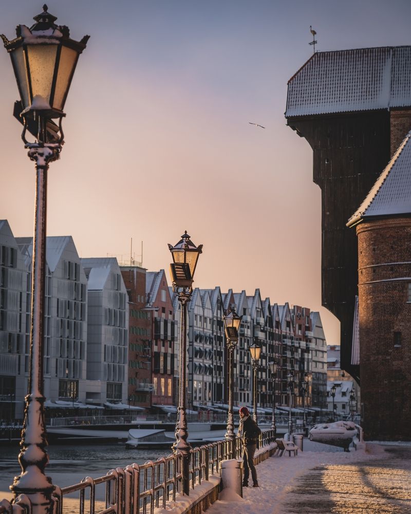 Snow covered pedestrian walkway outside Gdańsk's Crane