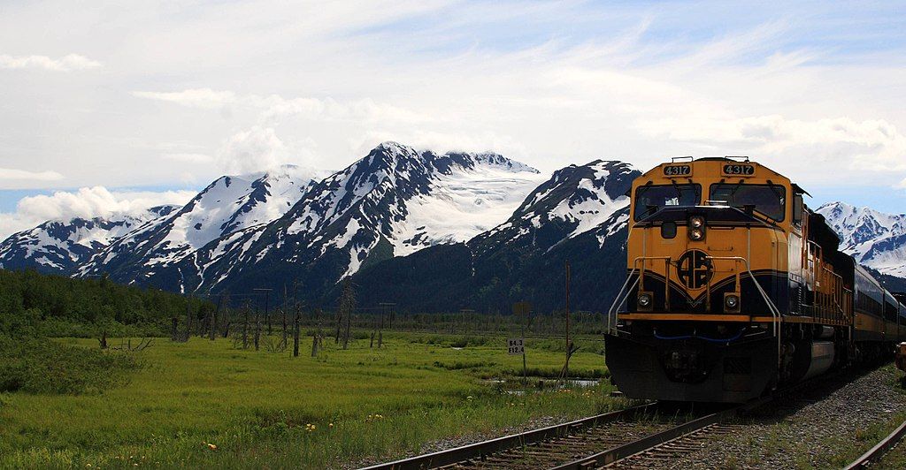 Glacier Discovery Train passing through scenic snow capped mountains