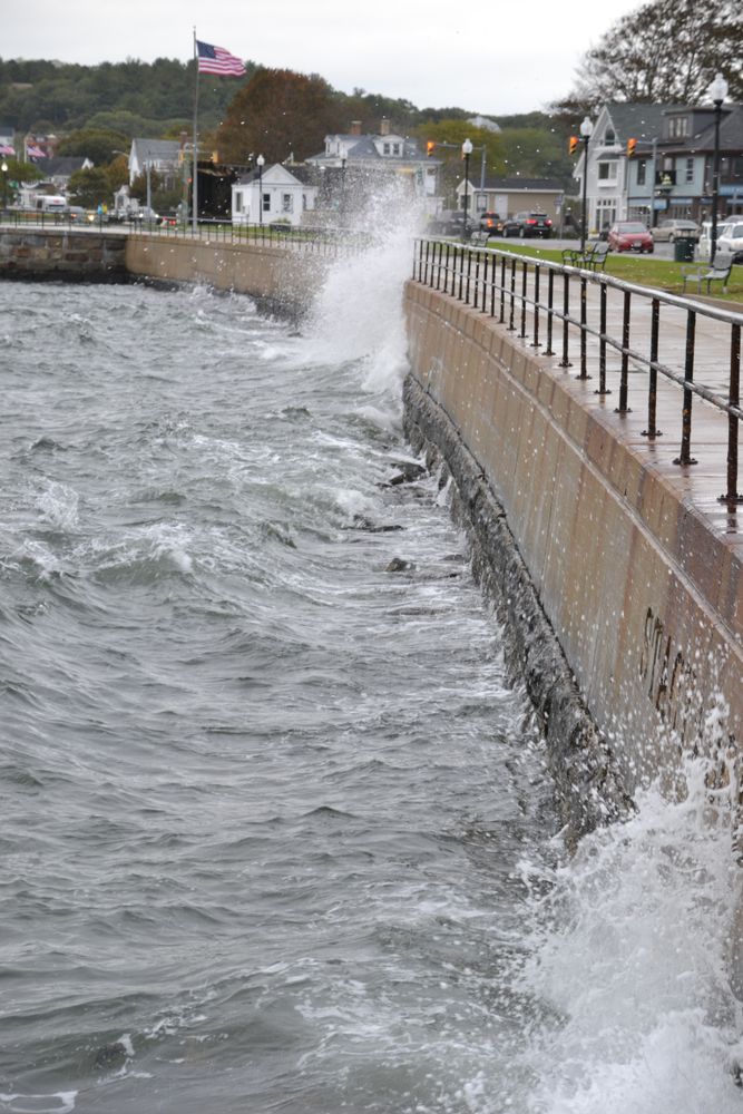 Waves crashing on the fence at Gloucester Fishermen Memorial