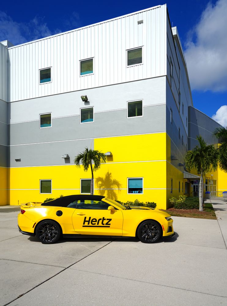 Yellow color Hertz car parked at Hertz Arena