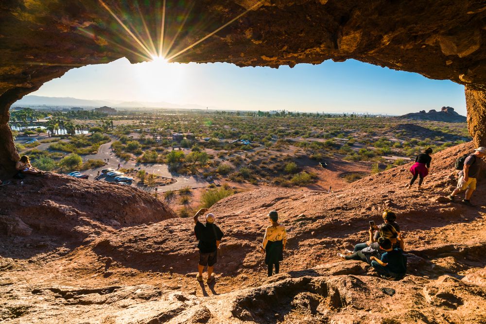 Hikers enjoying the sunset from Hole in the Rock in Papago Park