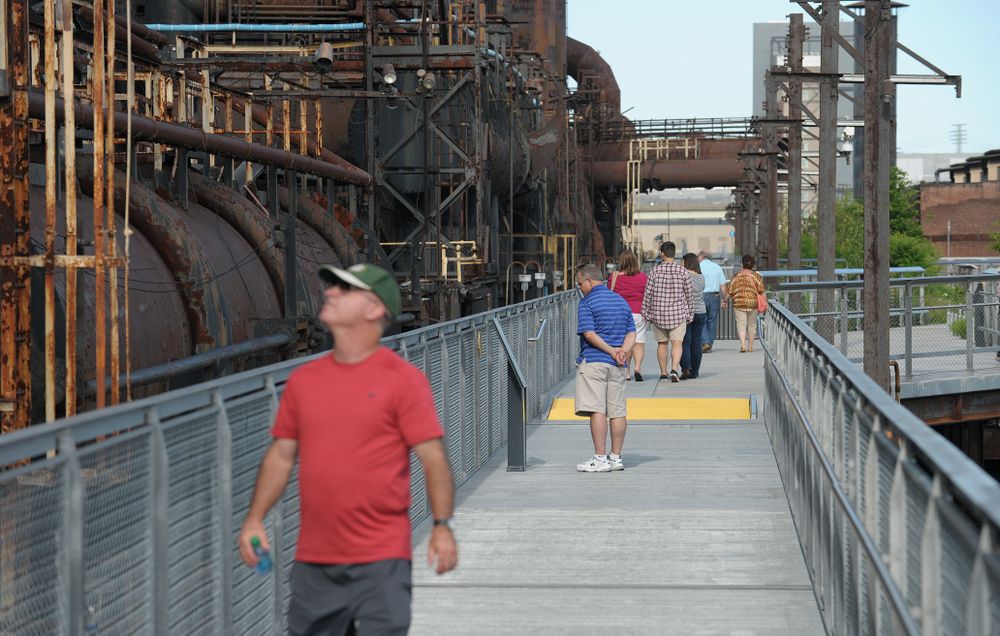 Tourists looking at the old industrial equipments at Hoover-Mason Trestle