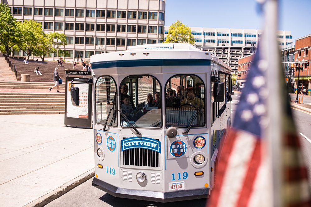 People travelling in Hop-On, Hop-Off Trolley Tour bus