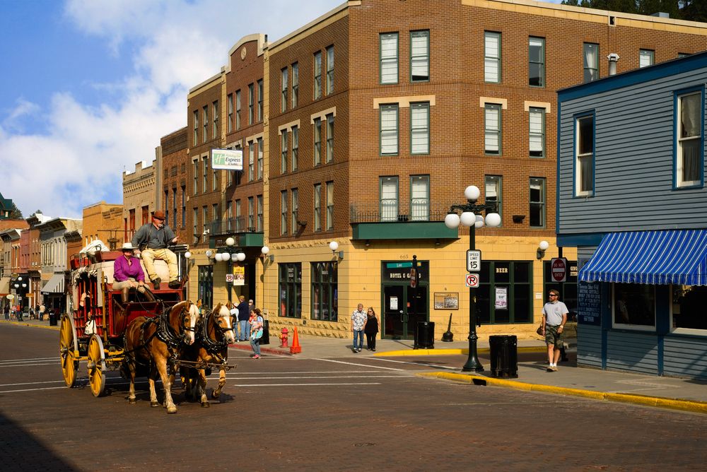 An elderly couple riding the horse carriage at Deadwood, SD
