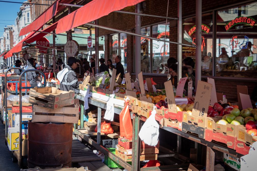 People buying fresh fruits at Italian Market