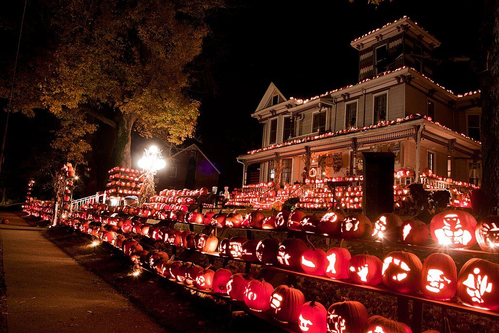 Night view of Kenova's Pumpkin House decored with lit pumpkin