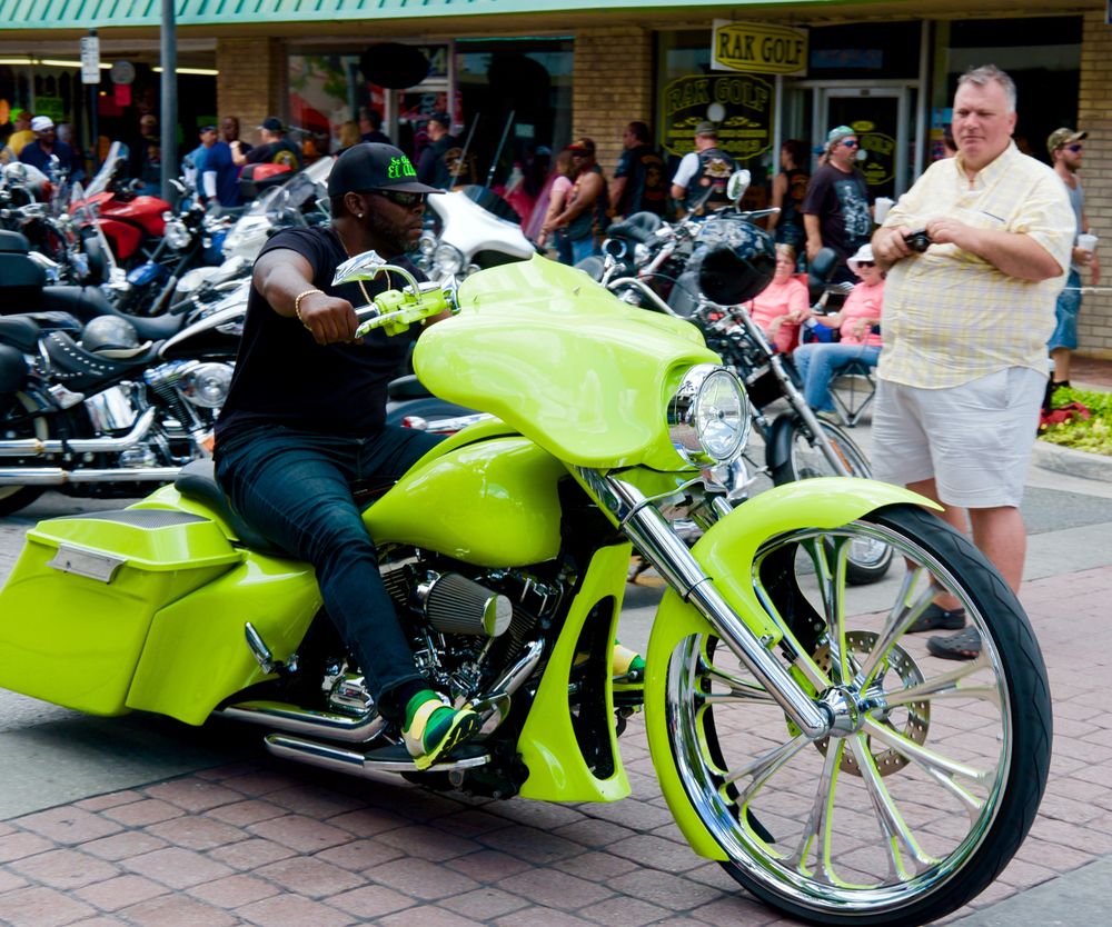 A guy flexing his bike during the festival.