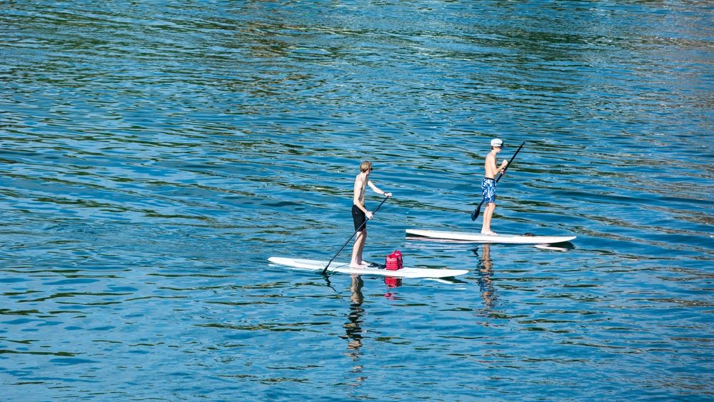 Two people paddle-boating on London Bridge Beach