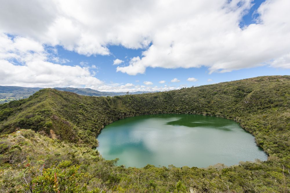 The clouds reflecting on the waters of Lake Guatavita