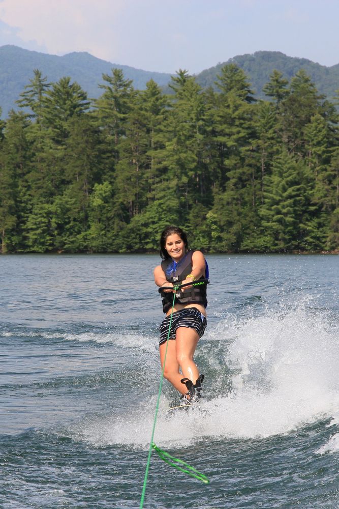 A young woman wakeboarding in Lake Santeetlah