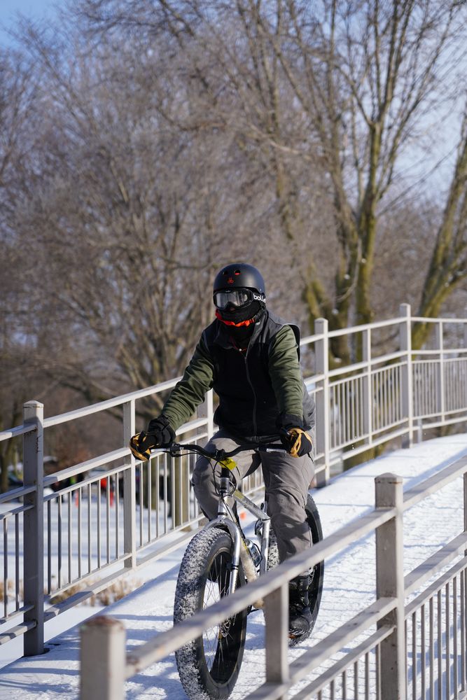 A man riding a cycle at Lakeside Park during winter