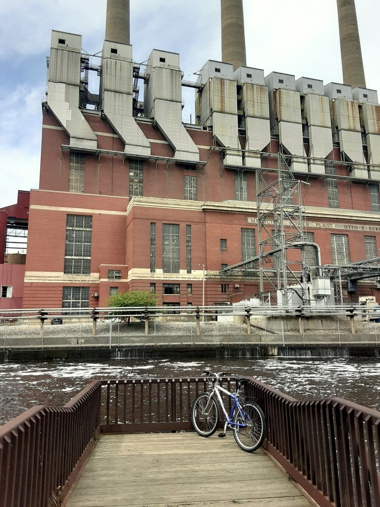 End of a bridge overlooking a power plant at Lansing River Trail