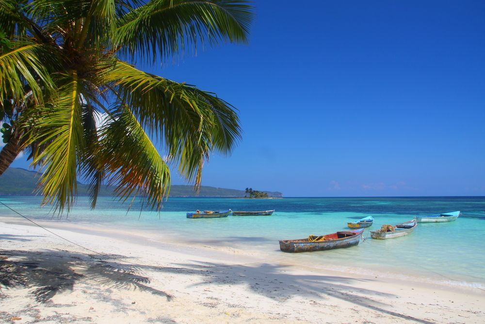 Boats docked on a calm beach at Las Galeras