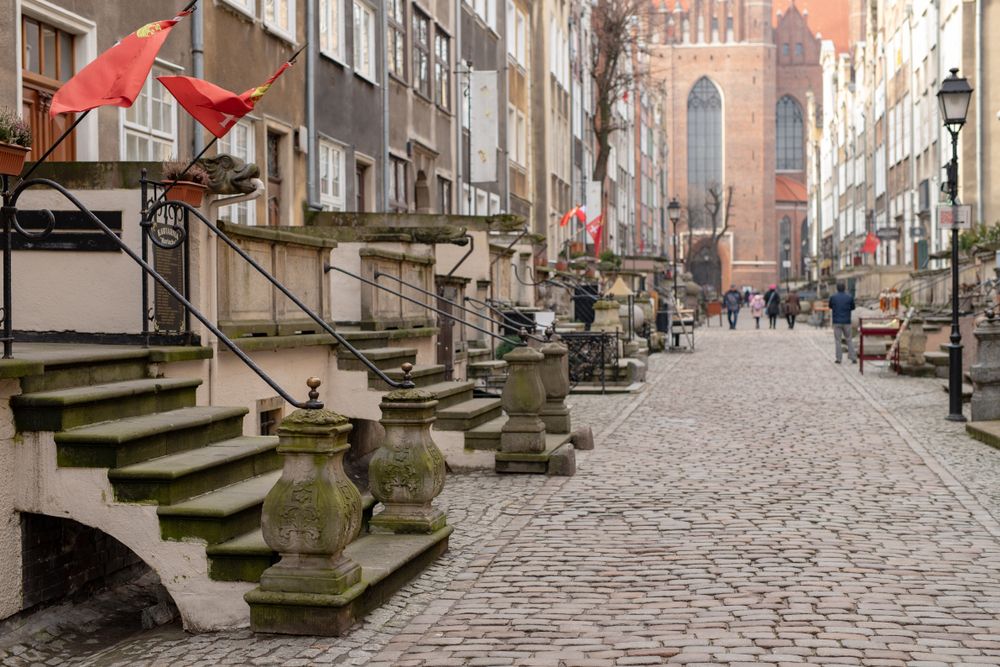 People walking on the cobble stoned path at Mariacka Street
