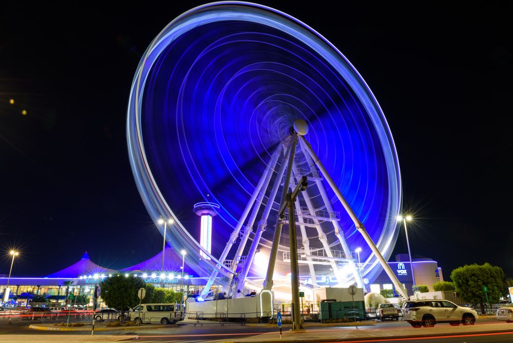 Night view of rotating Marina Eye with the Marina Mall entrance in the background
