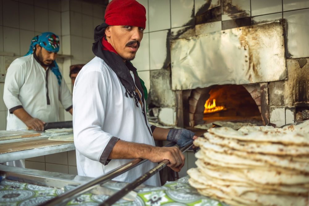 Men baking traditional arabian breads at Abu Dhabi