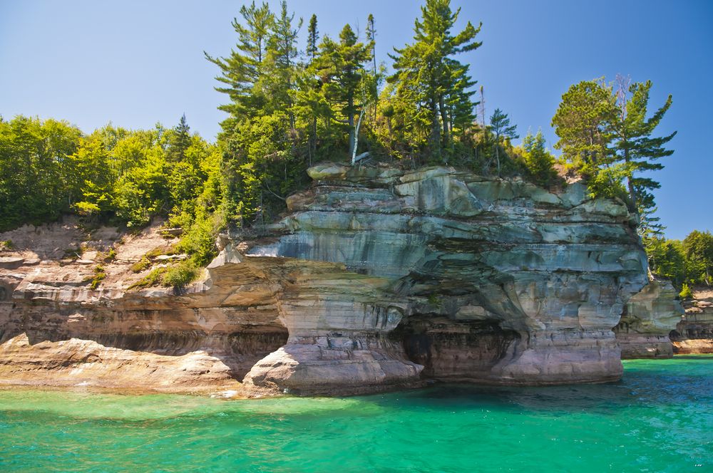 Miners Castle surrounded by green plants 