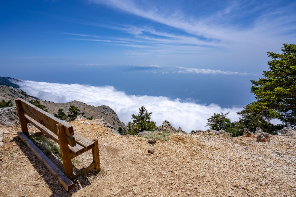 A wooden bench near a cliff of Mount Ainos National Park