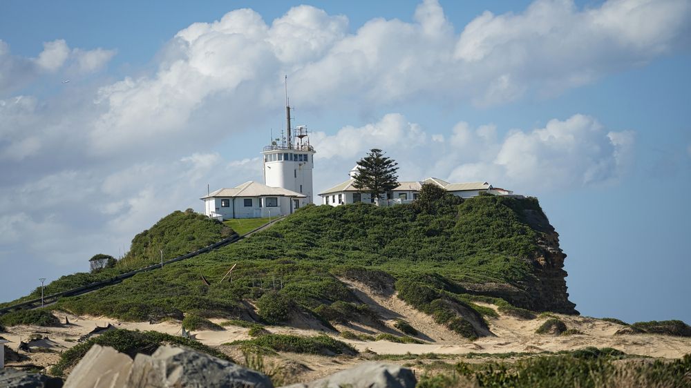 Nobbys Lighthouse standing high on a hillock