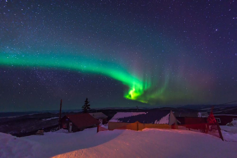 Northern Lights over log cabins