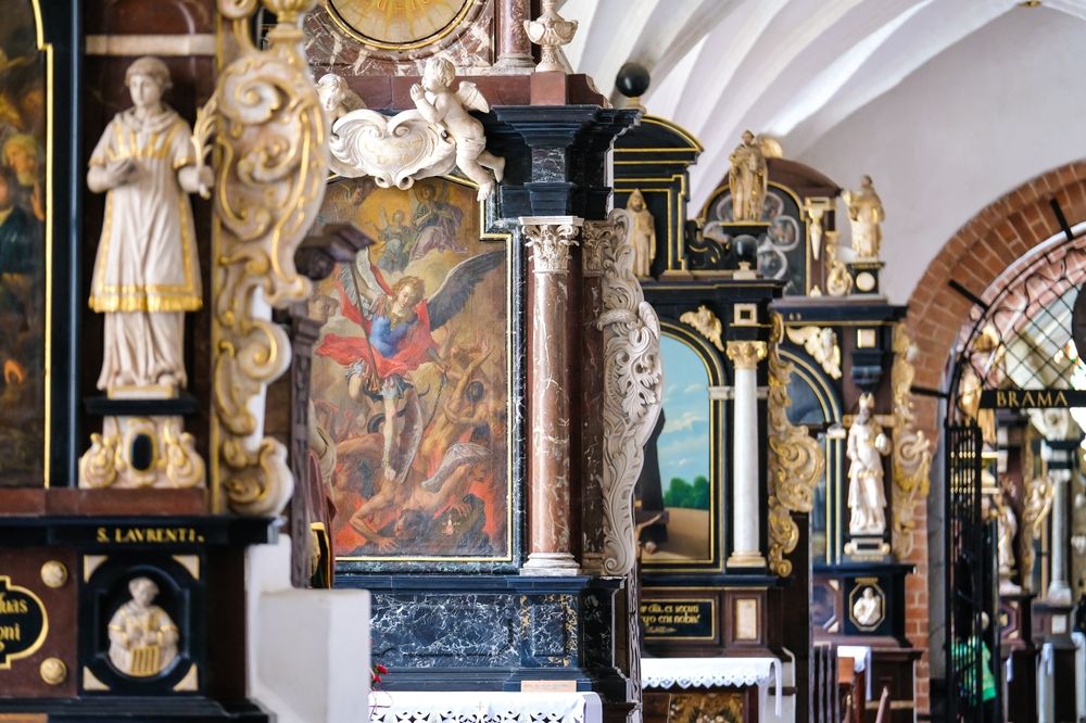 Display of saint's paintings and statues at Oliwa Cathedral