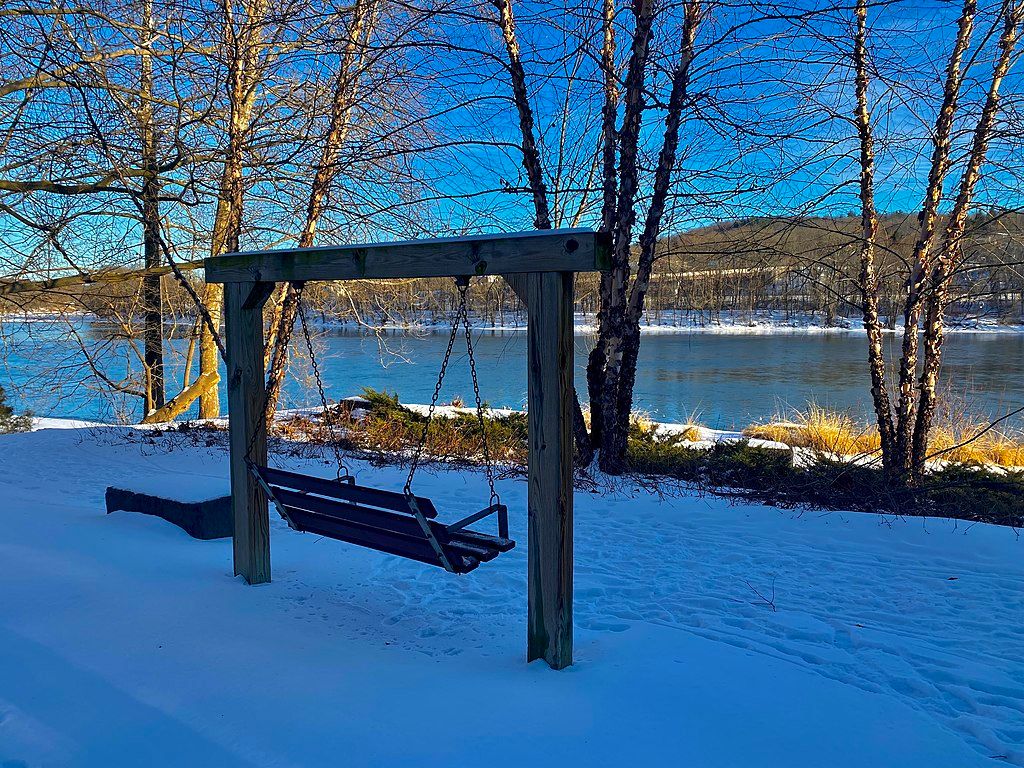 A wooden bench overlooking the river at Owego Riverwalk