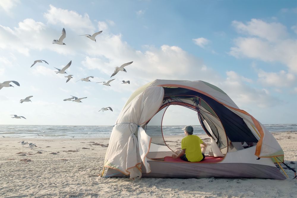 A man enjoying the view from his camping tent at Padre Island National Seashore
