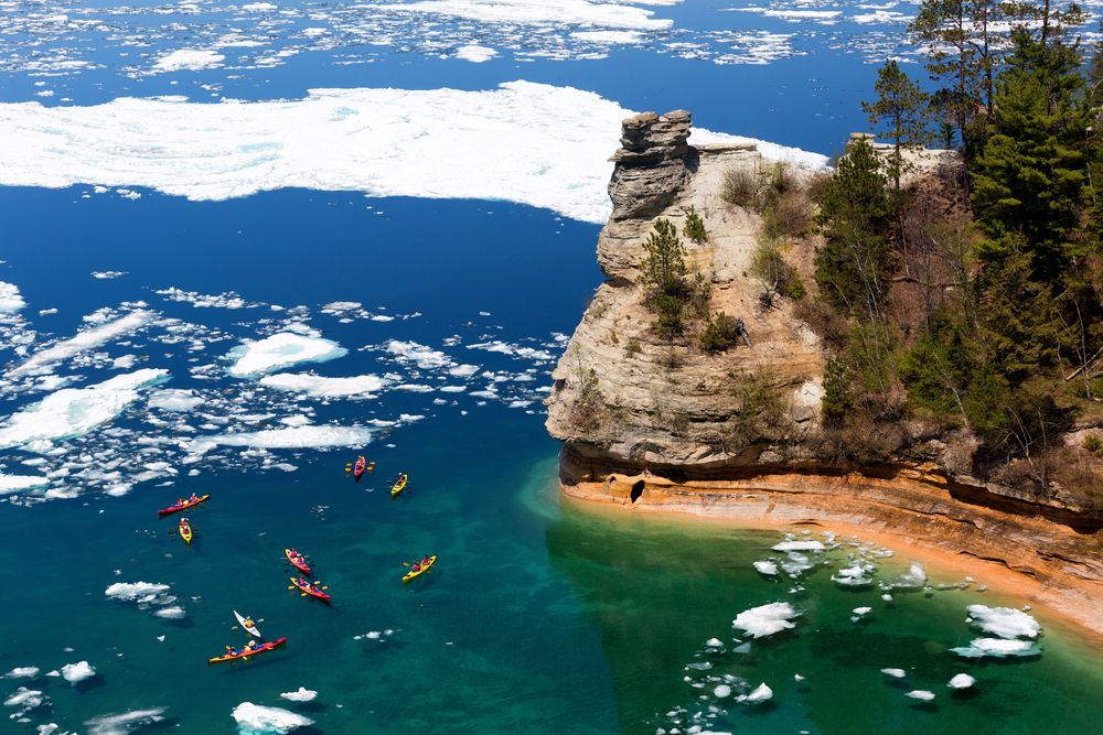 People kayaking in Pictured Rocks during snow